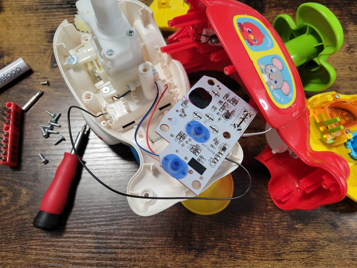 A disassembled children's helicopter toy
